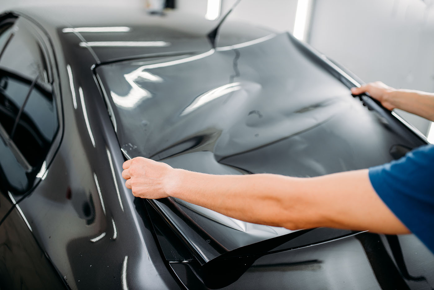 male-specialist-with-car-tinting-film-in-hands-2024-11-26-18-28-22-utc