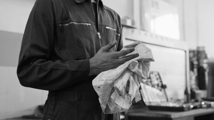 Man wiping hands with rag after car tinting