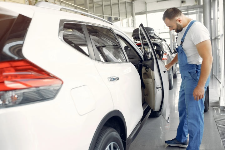 Man Inspecting Own Car Tint